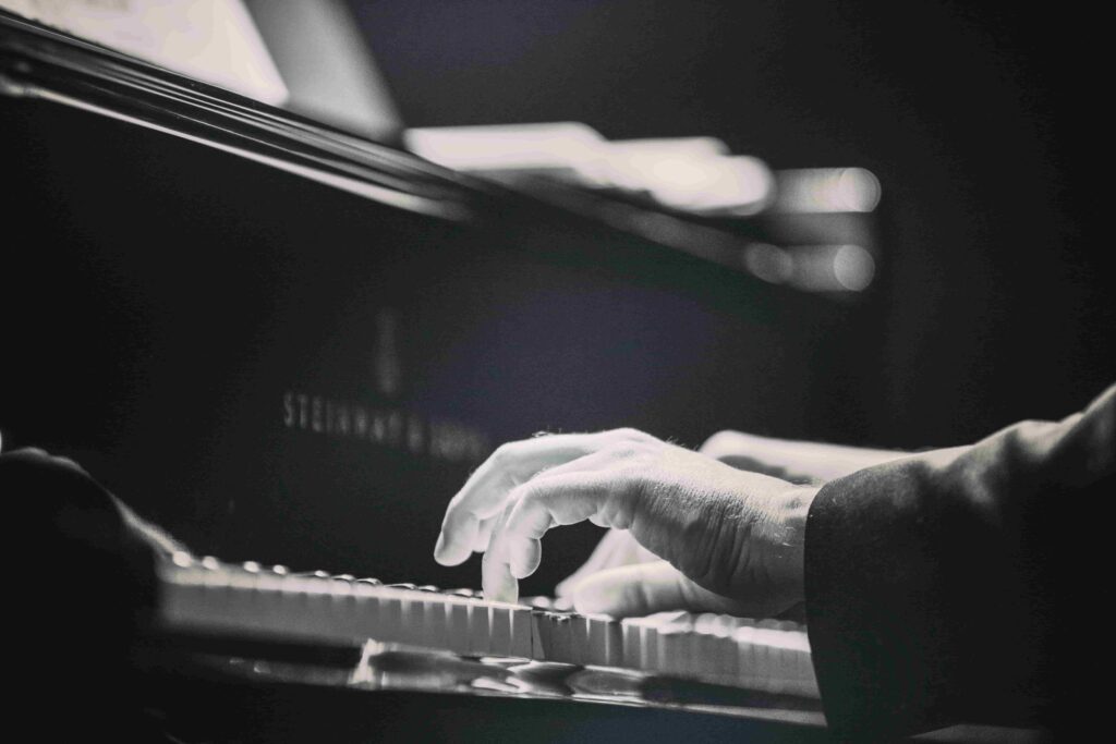 Man's hands play on the piano 