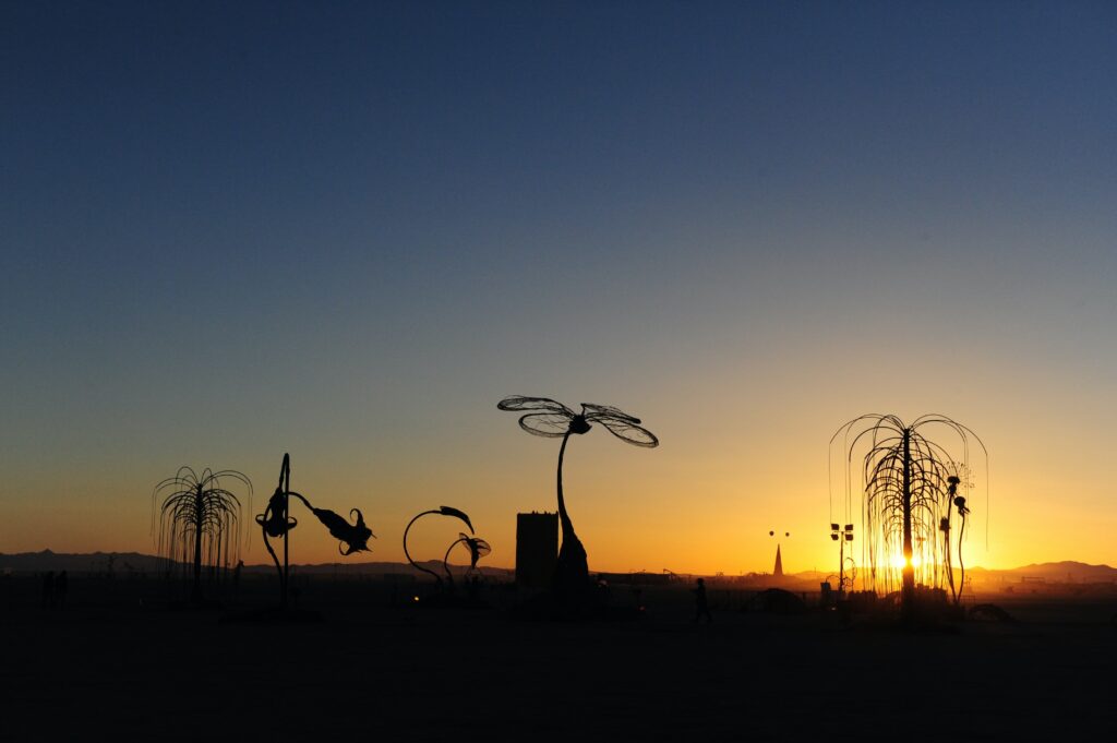 Burning man Art work in sunset 